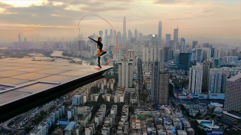 Angela Nikolau performing on top of a building.