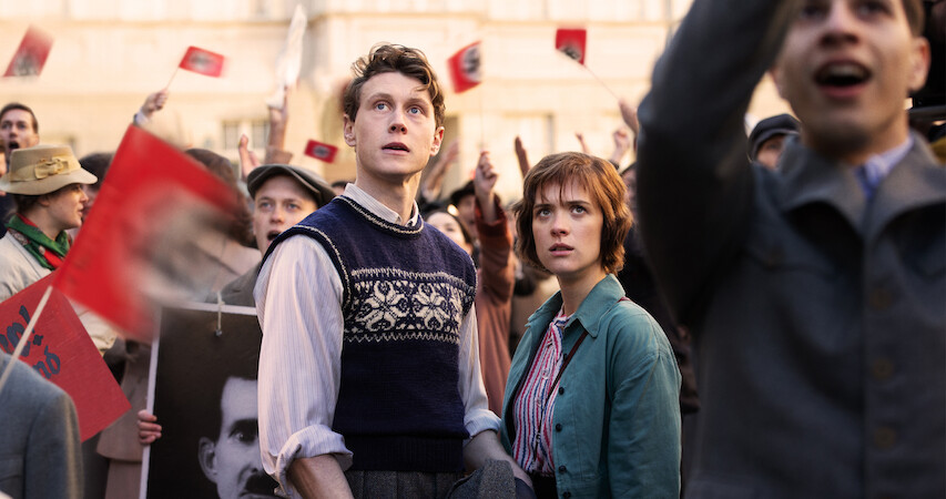 Hugh Legat and female partner look on in horror at a Nazi gathering