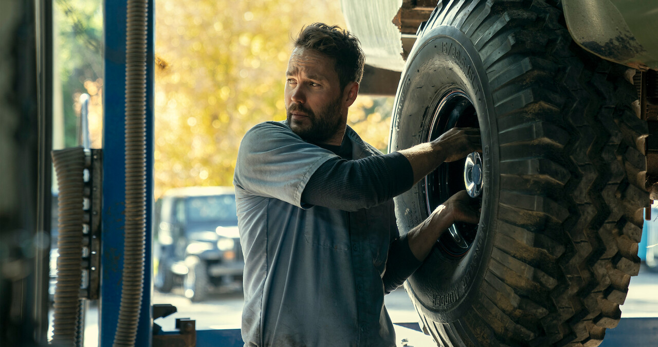 Taylor Kitsch as Glen Kryger works on a car in Season 1 of 'Painkiller.'