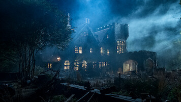 Old, abandoned mansion at night surrounded by overgrown vegetation, eerie mist, and dramatic lighting creating a spooky, haunted atmosphere. Broken windows and ruined walls add to the mysterious, unsettling mood of the scene.