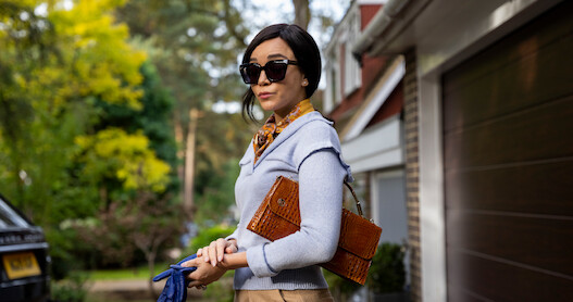Sharp-dressed woman in shades with expectant expression