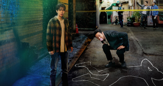 Choi Woo-shik as Lee Tang and Son Suk-ku as Jang Nan-gam stand together at a crime scene in Season 1 of 'A Killer Paradox'