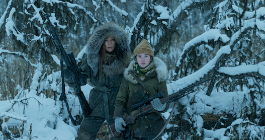 Jennifer Lopez and Lucy Paez stand in the Alaskan wilderness in a still from 'The Mother'