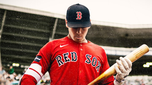 A Boston Red Sox player steps up to bat.