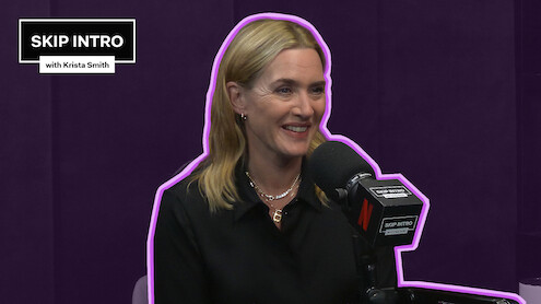 Kate Winslet smiles while speaking into a podcast microphone in a purple studio, outlined with a neon accent, with a “Skip Intro with Krista Smith” graphic in the corner.