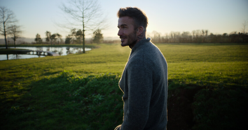 David Beckham standing outside.