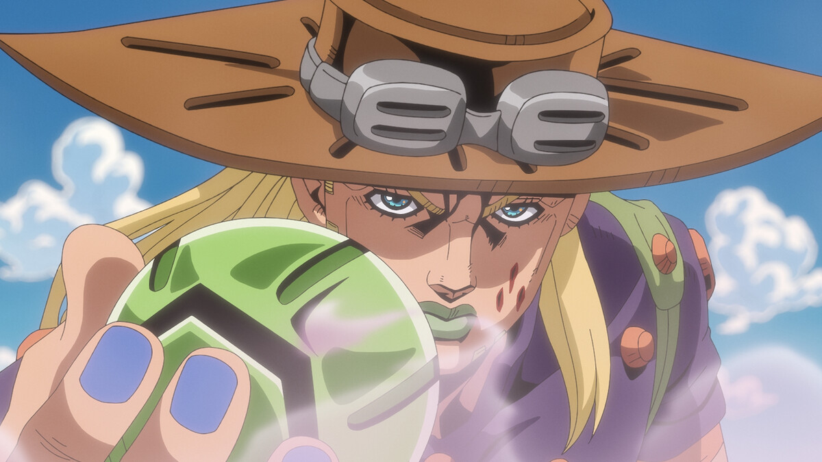 Anime character with long blonde hair, wearing a brown wide-brimmed hat and goggles, holding a green steel ball, with blue sky and clouds in the background. Character has intense expression and purple-painted nails.