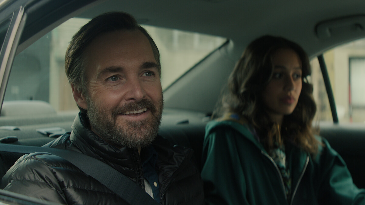 Will Forte as Gilbert Power smiles in the backseat of a car in 'Bodkin'
