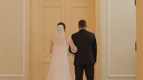 A 'Love Is Blind: Germany' single on her wedding day waits behind a door with her back facing the viewer.
