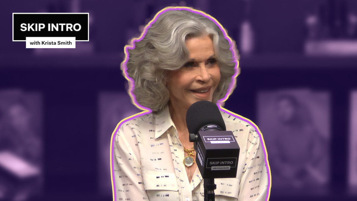 Jane Fonda sitting in front of a microphone, with the 'Skip Intro' logo positioned in the upper left corner.