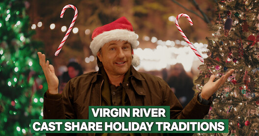 Martin Henderson (Jack Sheridan) wears a red Santa hat in front of a Christmas tree backdrop.