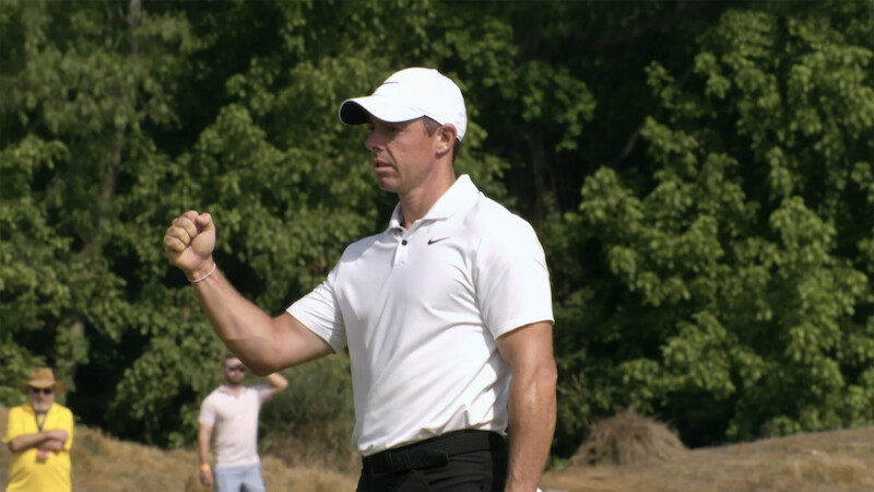 Rory McIlroy raises his fist in celebration.