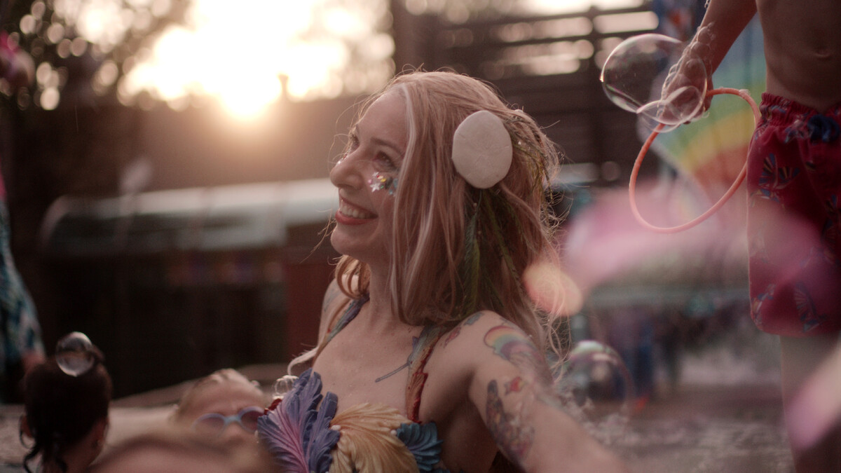 Mermaid Sparkles smiling in a pool in MerPeople