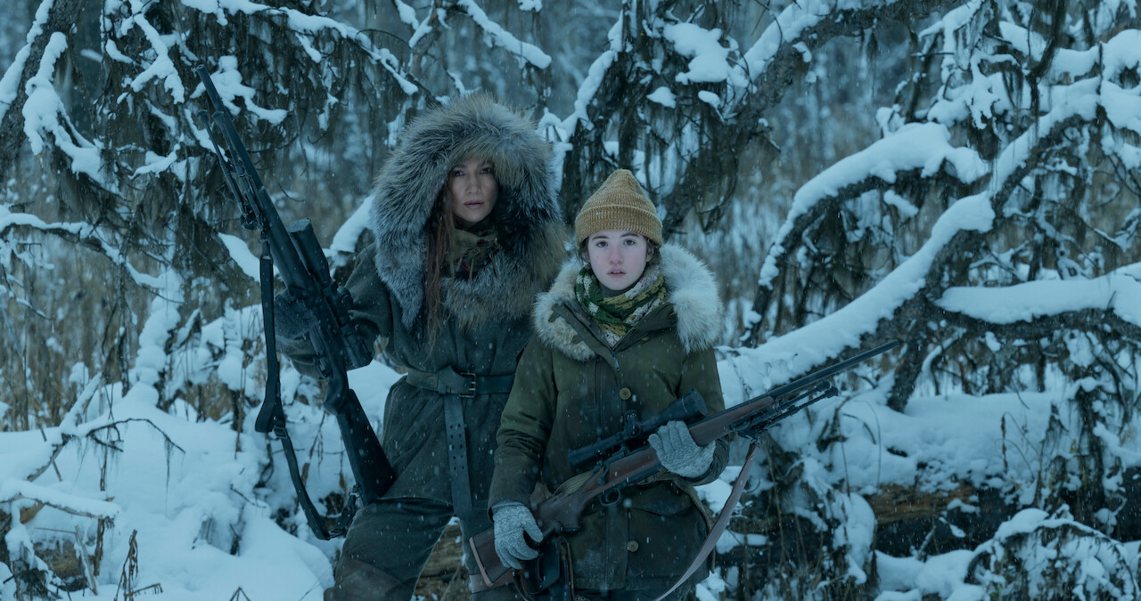 Jennifer Lopez and Lucy Paez stand in the Alaskan wilderness in a still from 'The Mother'