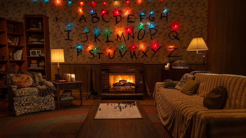 'Stranger Things' fireplace in a living room with an alphabet wall
