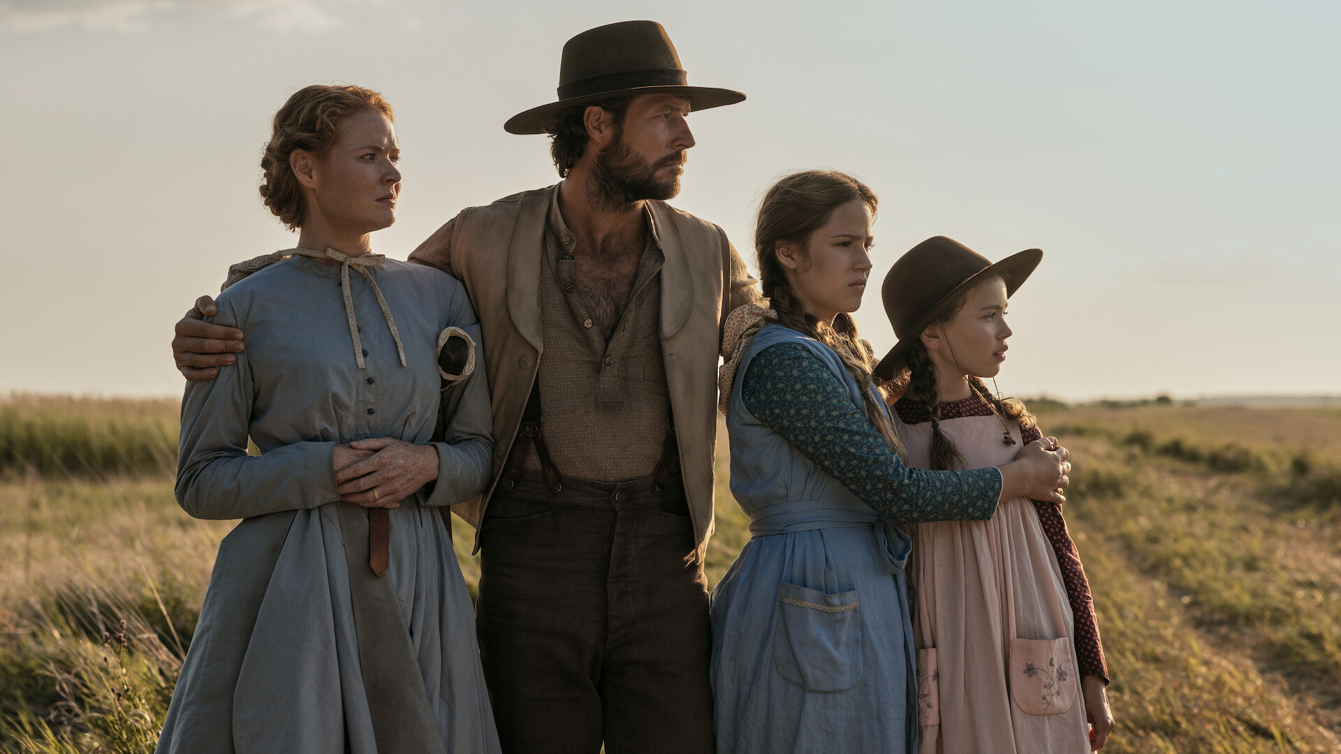 A family looks off into the distance together. 