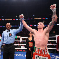 The referee raises the arm of Callum Walsh after he won by unanimous decision against Fernando Vargas Jr. in their light middleweight bout during Netflix's Canelo v Crawford Fight Night at Allegiant Stadium