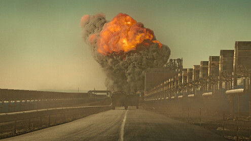 Trucks drive towards a large explosion in 'The Wages of Fear'