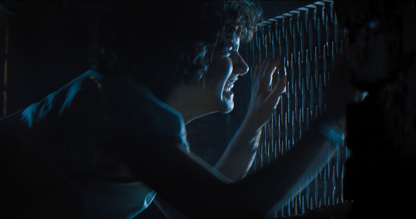 A terrified Melody peeks through a grate to get away