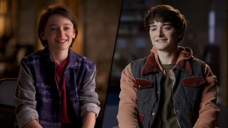 Split image featuring a younger Noah Schnapp on the left and an older version on the right, both seated indoors, smiling, and dressed casually in soft, natural lighting.