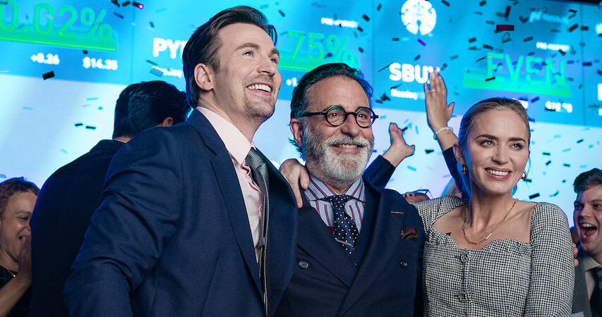 Chris Evans, Andy Garcia and Emily Blunt celebrate in a scene from 'Pain Hustlers.'