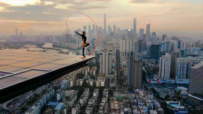 Angela Nikolau performing on top of a building.