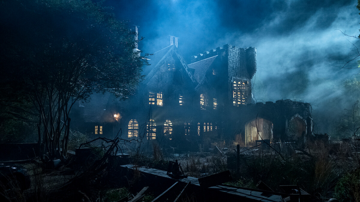 Old, abandoned mansion at night surrounded by overgrown vegetation, eerie mist, and dramatic lighting creating a spooky, haunted atmosphere. Broken windows and ruined walls add to the mysterious, unsettling mood of the scene.