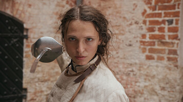 A woman looking fierece with a sword