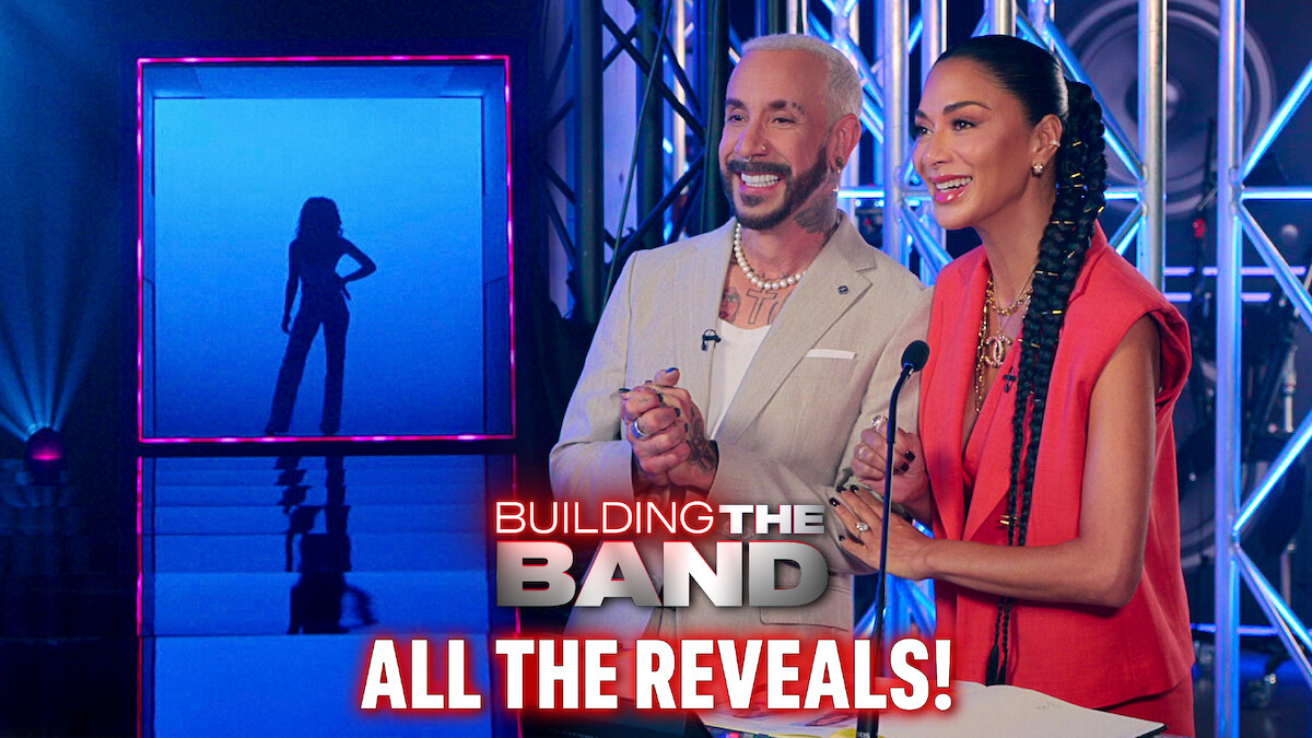 AJ McLean and Nicole Scherzinger smiling on a music competition show with a silhouette display on the left side.