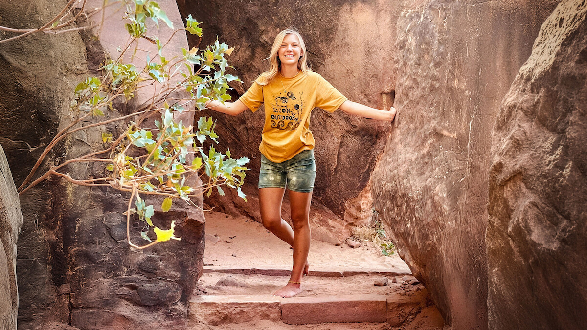 A photograph of Gabby Petito posing on a trail. 