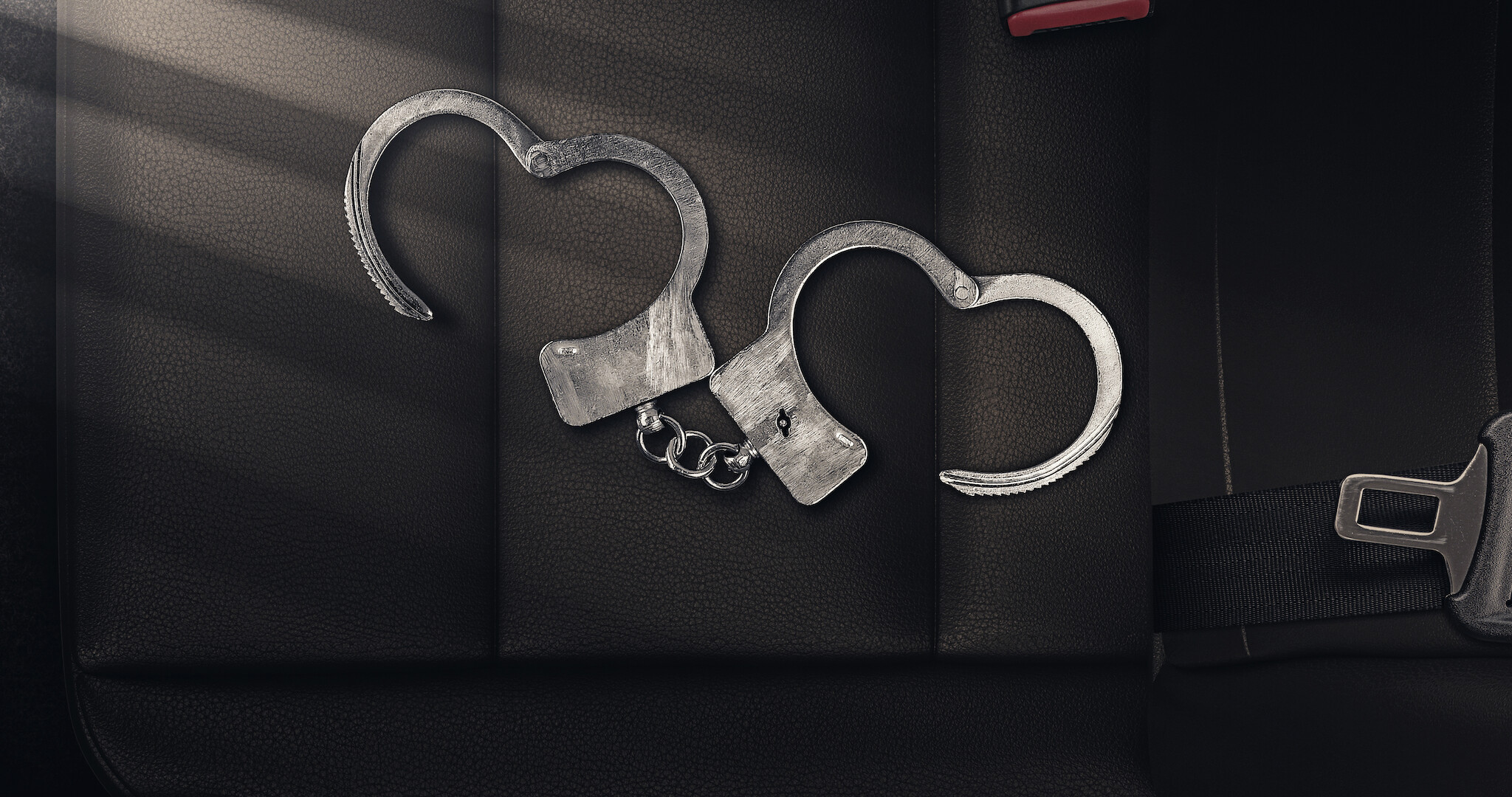 A photo of handcuffs that form the shape of a heart. 