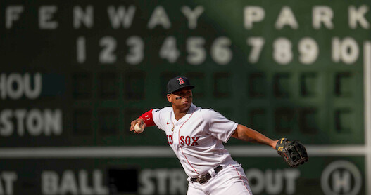 Rafael Devers of the Boston Red Sox throws during the first inning of a game against the Houston Astros at Fenway Park in Boston.