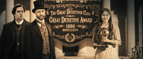 Three people in Victorian-era attire stand before a banner reading "The Great Detectives Club Great Detective Award 1886"; one woman holds a trophy, the scene set within grand architectural columns, evoking a formal ceremony.