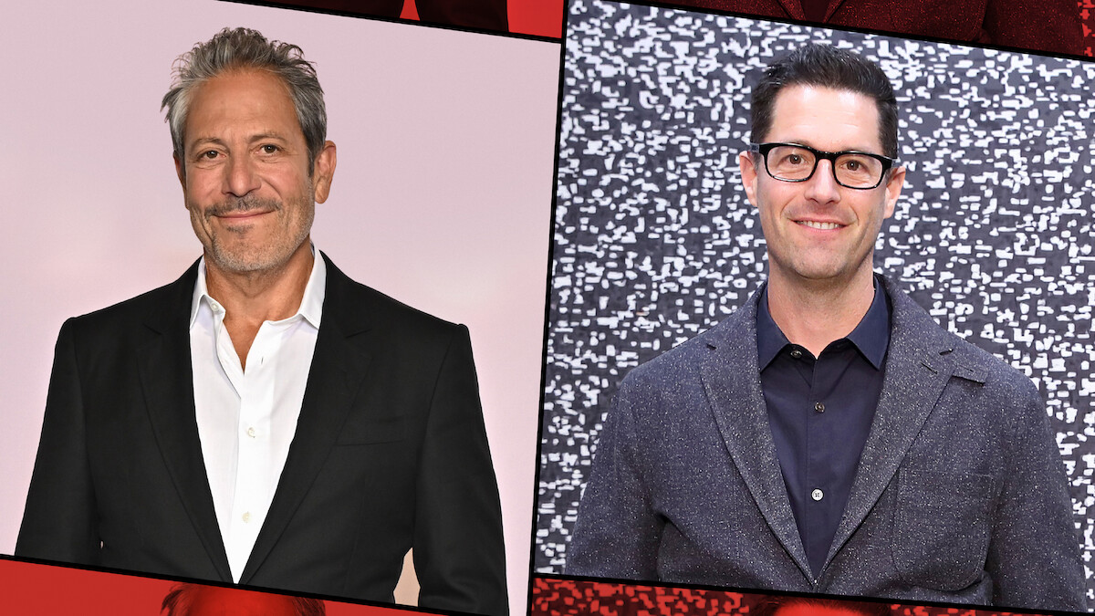 Two men in suits pose separately against different backdrops; the man on the left stands before a plain light background, while the man on the right stands in front of a patterned black and white wall. Both are smiling and appear at a formal event.