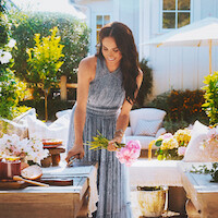 Meghan cuts a bouquet of flowers outside.