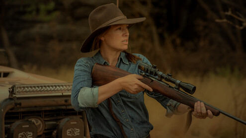  Anna Torv as Emily Lawson holds up a rifle in Season 1 of 'Territory'
