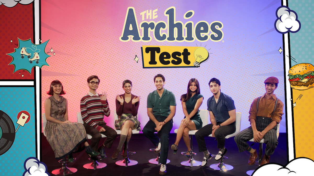 The cast of 'The Archies' seated on a stage together
