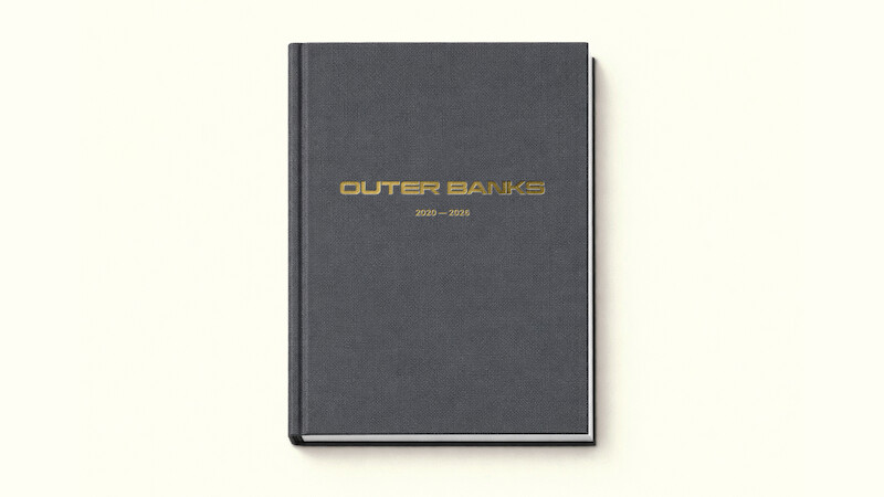 A black hardcover book with gold "Outer Banks 2020–2025" text on the cover, photographed on a plain off-white background.