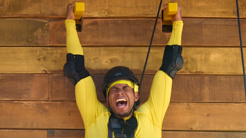Louis yells while doing a climbing challenge.