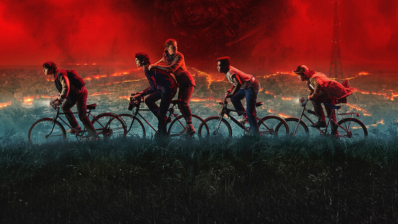 Key art for 'Stranger Things' 5 features the kids riding bikes under a red stormy sky.