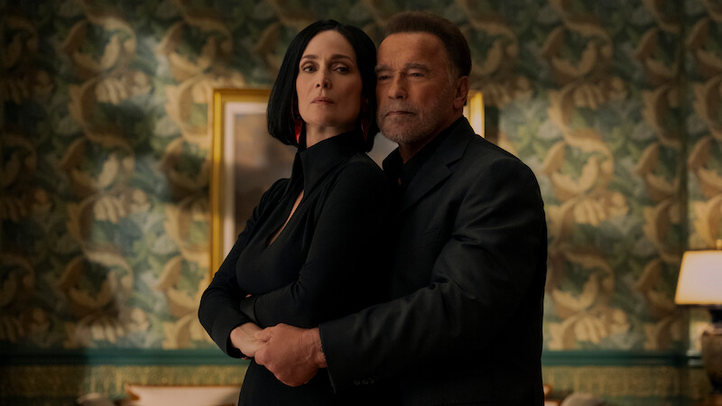 Carrie-Anne Moss as Greta Nelso and Arnold Schwarzenegger as Luke Brunner in Season 2 of 'FUBAR'