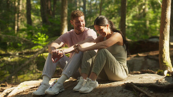 Ashley and Andrew on their hiking date, sitting and laughing