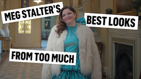 Actor Megan Stalter in a turquoise formal dress with a white fluffy jacket, looking fabulous. 