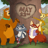 Four animated woodland animals stand in front of a large tree with "May 22nd" carved in a heart on the trunk, set in a forest with mountains in the background. The animals look cheerful and are holding wooden mallets.