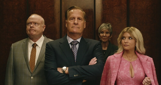 Jeff Daniels as Charlie Croker and Sarah Jones as Serena Croker walk through an office in 'A Man in Full'