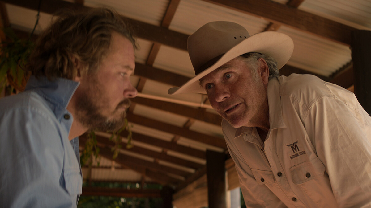 Two men in a barn intensely look at each other in Season 1 of 'Territory'