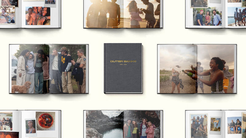Photo books open to various pages showing groups of friends, outdoor settings, celebrations, and candid moments, arranged around a closed book with “OUR FAMILY SNAPBOOK” on the cover, all set against a light background.