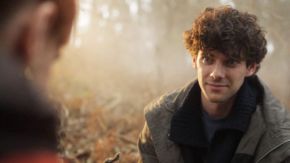  Álvaro Rico smiles while perched among a forest floor in an image from 'The Gardener.'