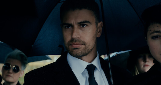 Theo James as Eddie Horniman wears a suit and holds an umbrella in season 1 of 'The Gentlemen'