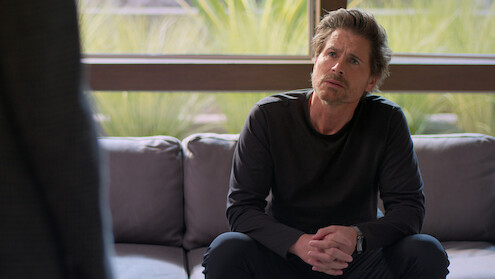 Rob Lowe sits on a couch in Season 2 of 'Unstable'
